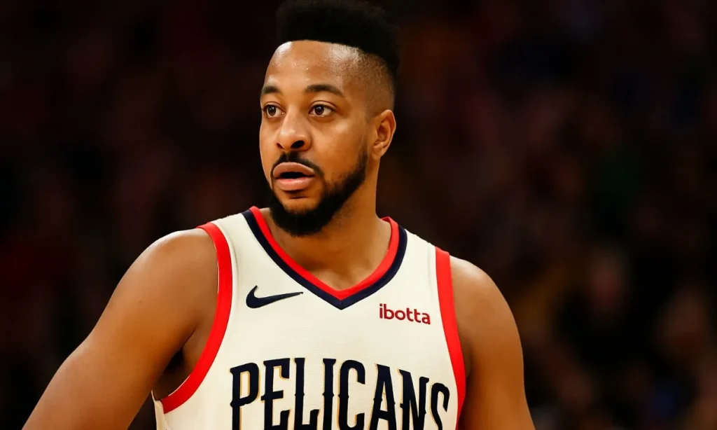 A headshot of CJ McCollum in his New Orleans Pelicans jersey, with a serious gaze, potentially during a significant period of the NBA Offseason.