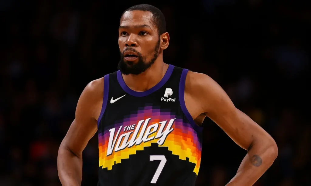 A close-up shot of Kevin Durant in his Phoenix Suns "The Valley" city edition jersey, looking focused on the court during the NBA Offseason.